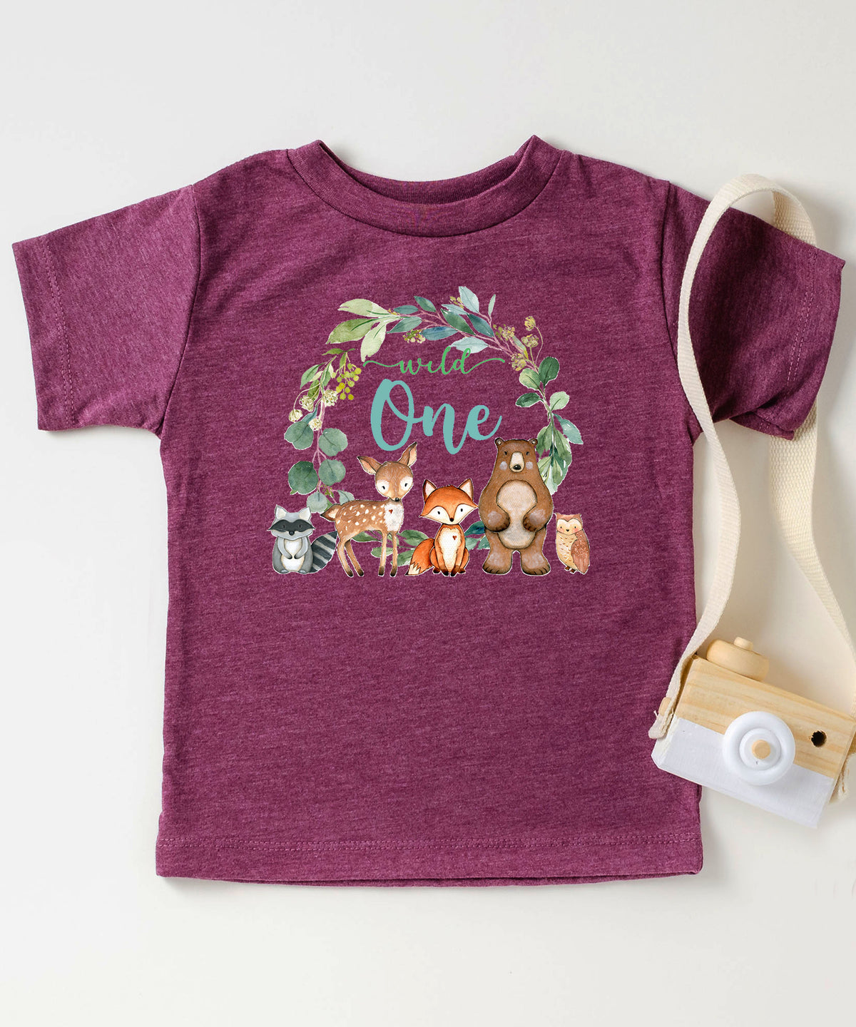 Vintage burgundy Wild One wreath first birthday tee flat lay front view