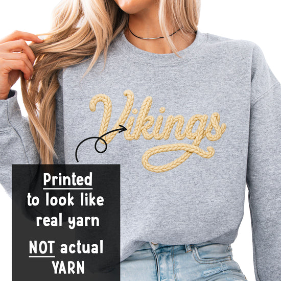 Close-up of the ink-printed Vikings yarn-look script lettering on the school spirit sweatshirt
