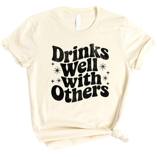 Drinks Well With Others funny graphic tee for women in Natural, lifestyle view