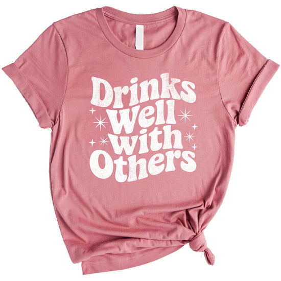 Drinks Well With Others funny graphic tee for women in Mauve, lifestyle view