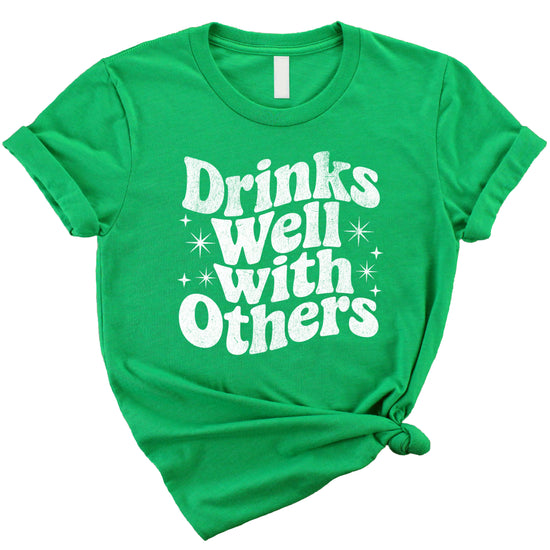 Drinks Well With Others funny graphic tee for women in Vintage Green, lifestyle view