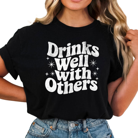 Drinks Well With Others funny graphic tee for women in Black, front view