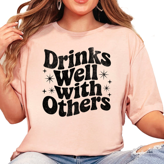 Drinks Well With Others funny graphic tee for women in Peach, detail view