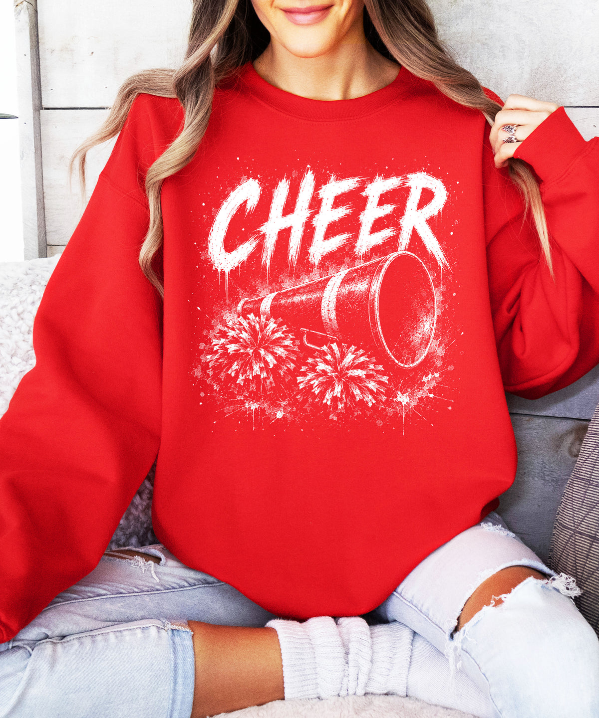Red cheerleader sweatshirt styled on a model, showing the relaxed crewneck fit