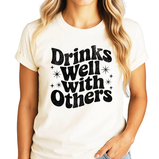 Drinks Well With Others funny graphic tee for women in Natural, front view