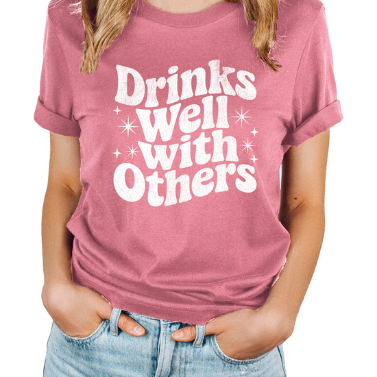 Drinks Well With Others funny graphic tee for women in Mauve, front view