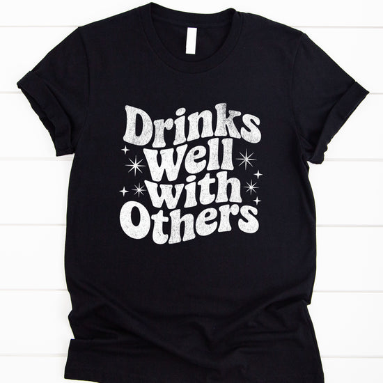 Drinks Well With Others funny graphic tee for women in Black, lifestyle view