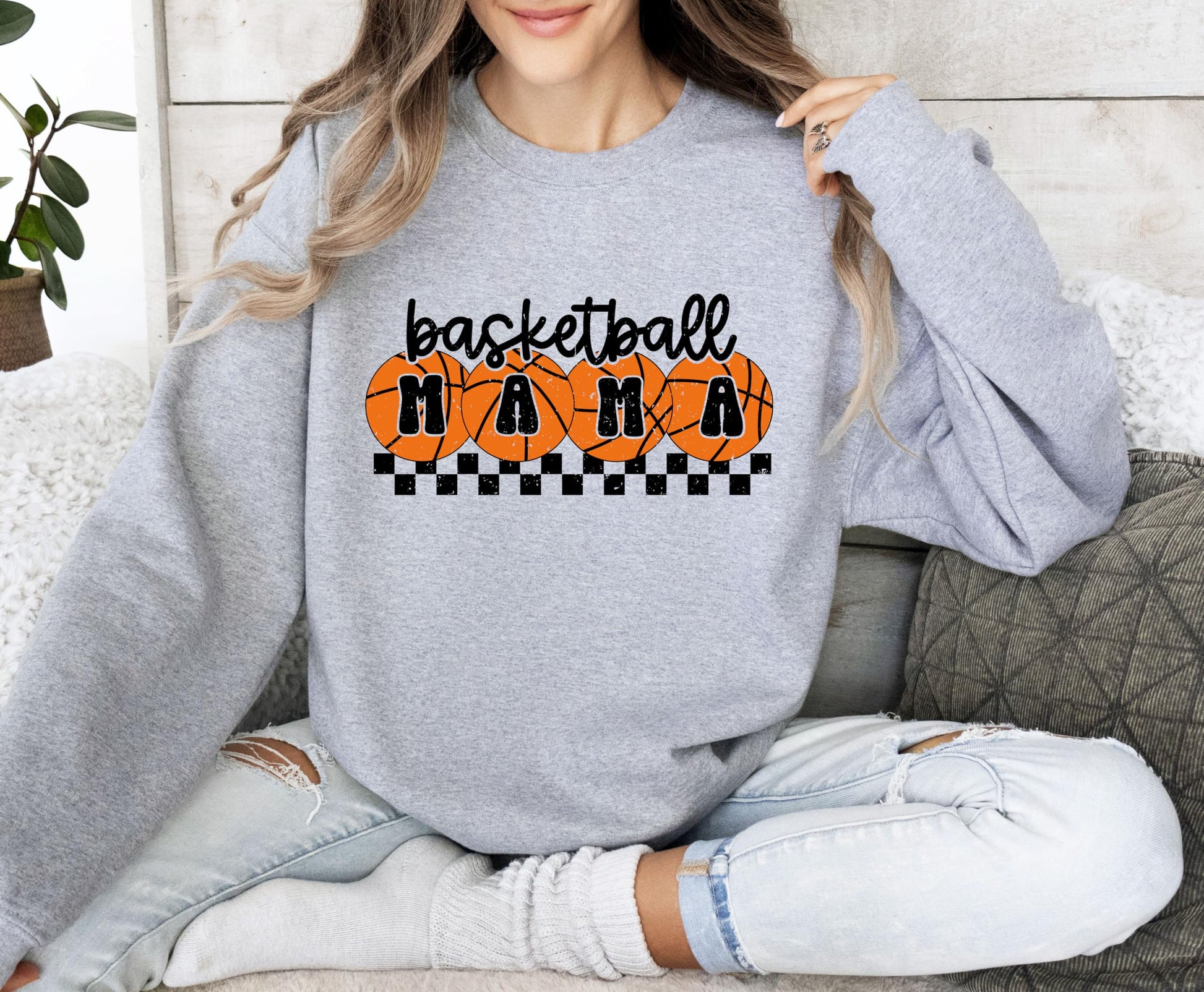 Model wearing white basketball mama crewneck sweatshirt with orange checkered design