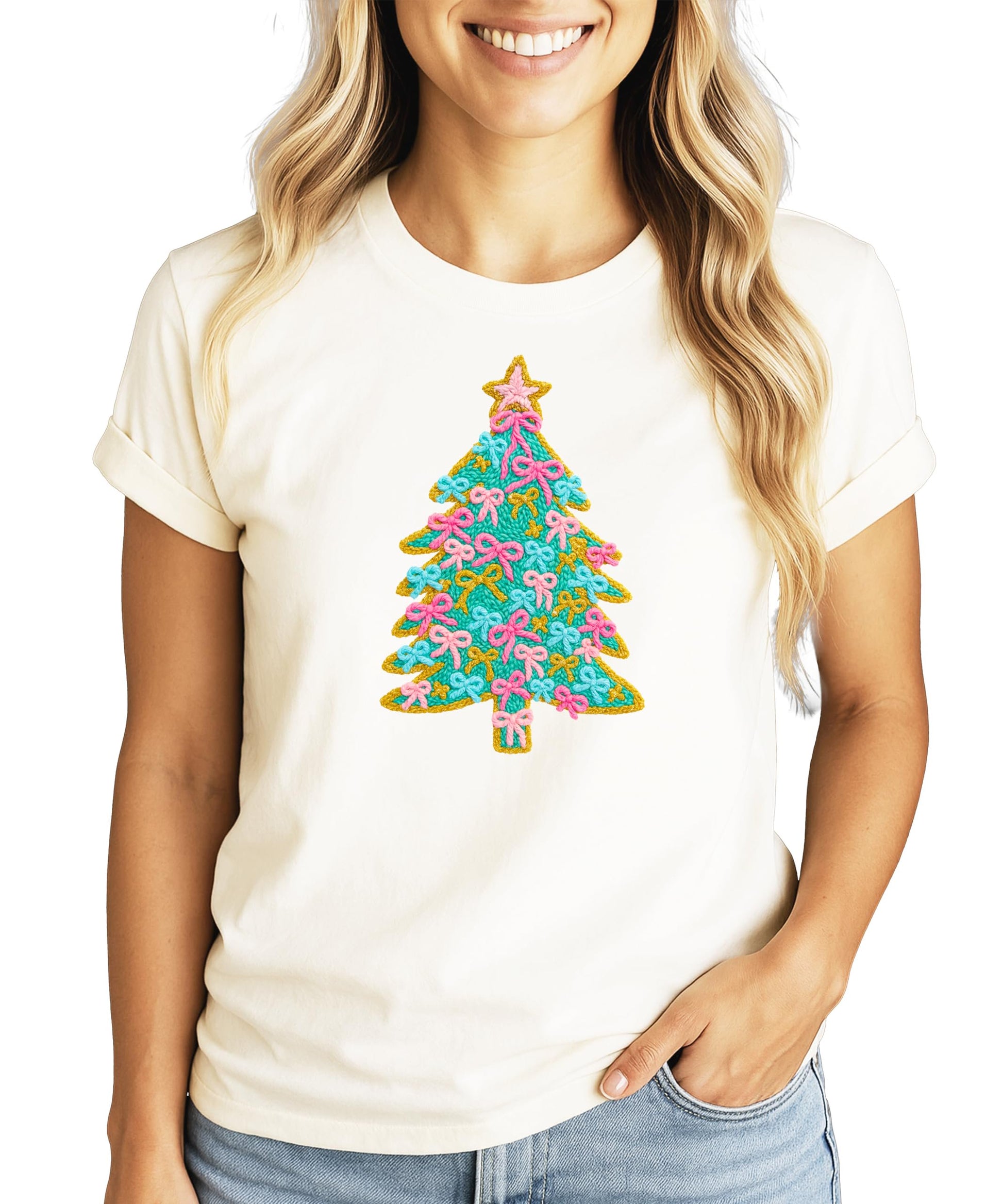 Close-up of Christmas tree ink print with pink bow ornaments and sparkling gold star on kids tee