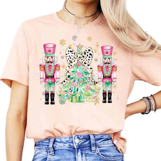 Youth girls wearing a peach Christmas nutcracker graphic tee for the holiday season
