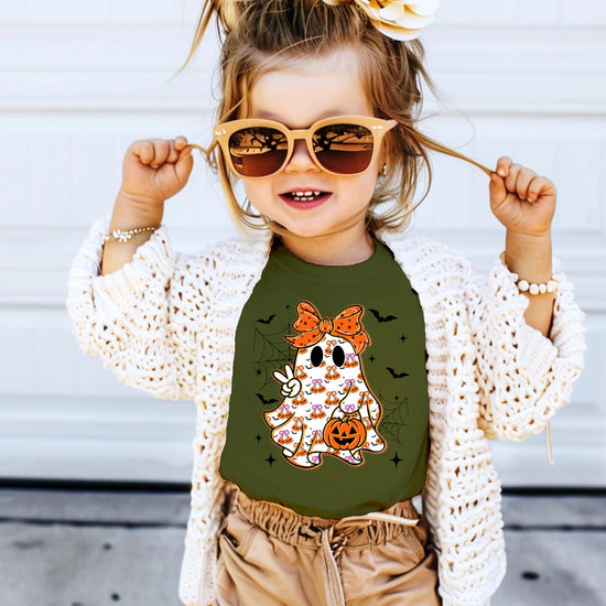 Detail shot of the ghost and orange bow graphic on a soft natural cotton kids Halloween shirt