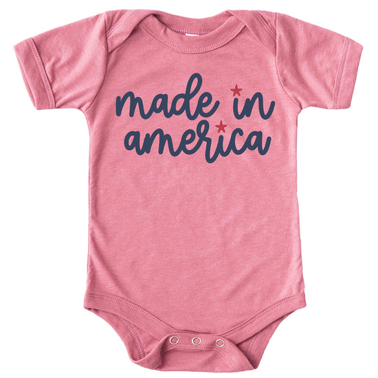 Toddler girl wearing pink Made in America shirt for Fourth of July celebration