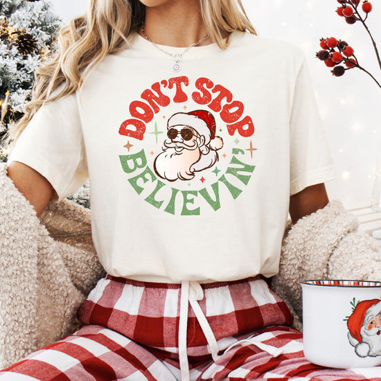 Detail shot of Don't Stop Believing Santa print on women's festive holiday shirt