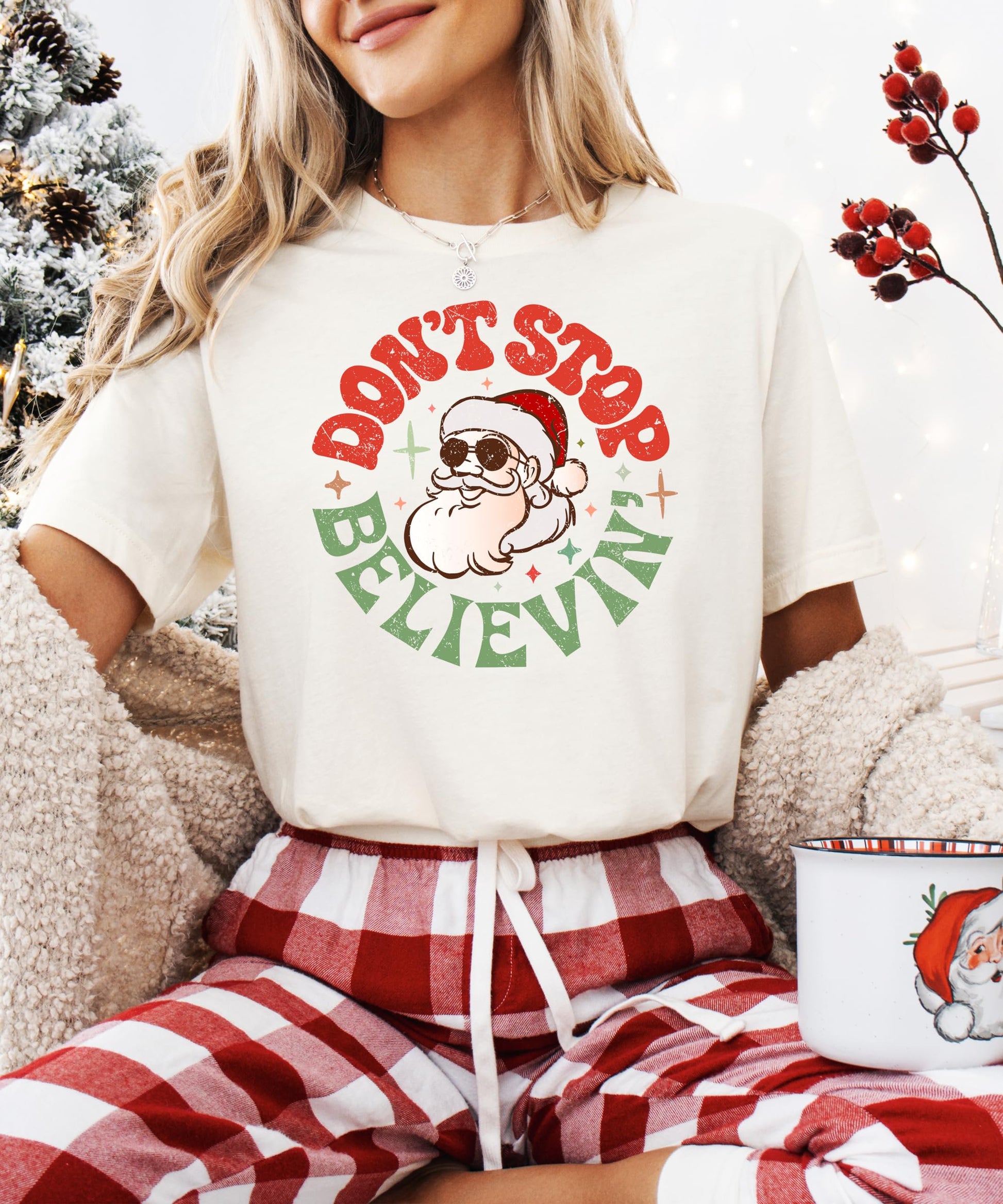 Detail shot of Don't Stop Believing Santa print on women's festive holiday shirt