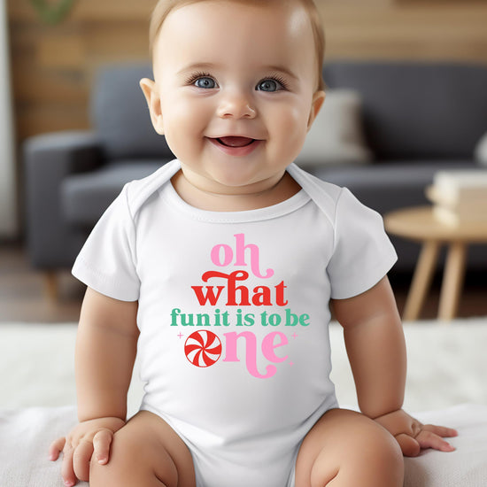 Baby girl wearing Oh What Fun It Is To Be One Christmas birthday one-piece bodysuit