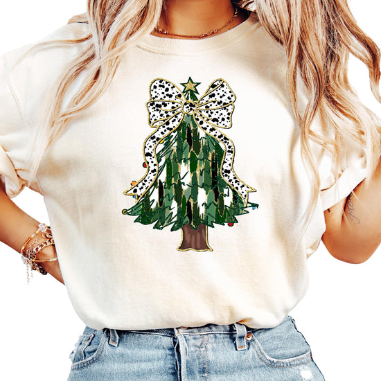 Flat lay or styled shot of ivory women's holiday graphic tee with Christmas tree and gold star topper
