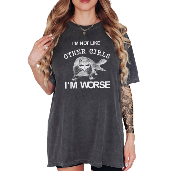 Close-up of raccoon graphic and 'I'm Not Like Other Girls I'm Worse' print on ivory tee