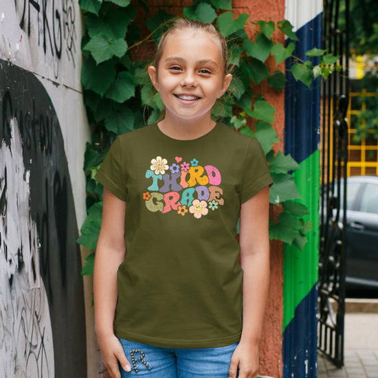 Flat lay of kids groovy daisy back to school shirt showing full graphic design