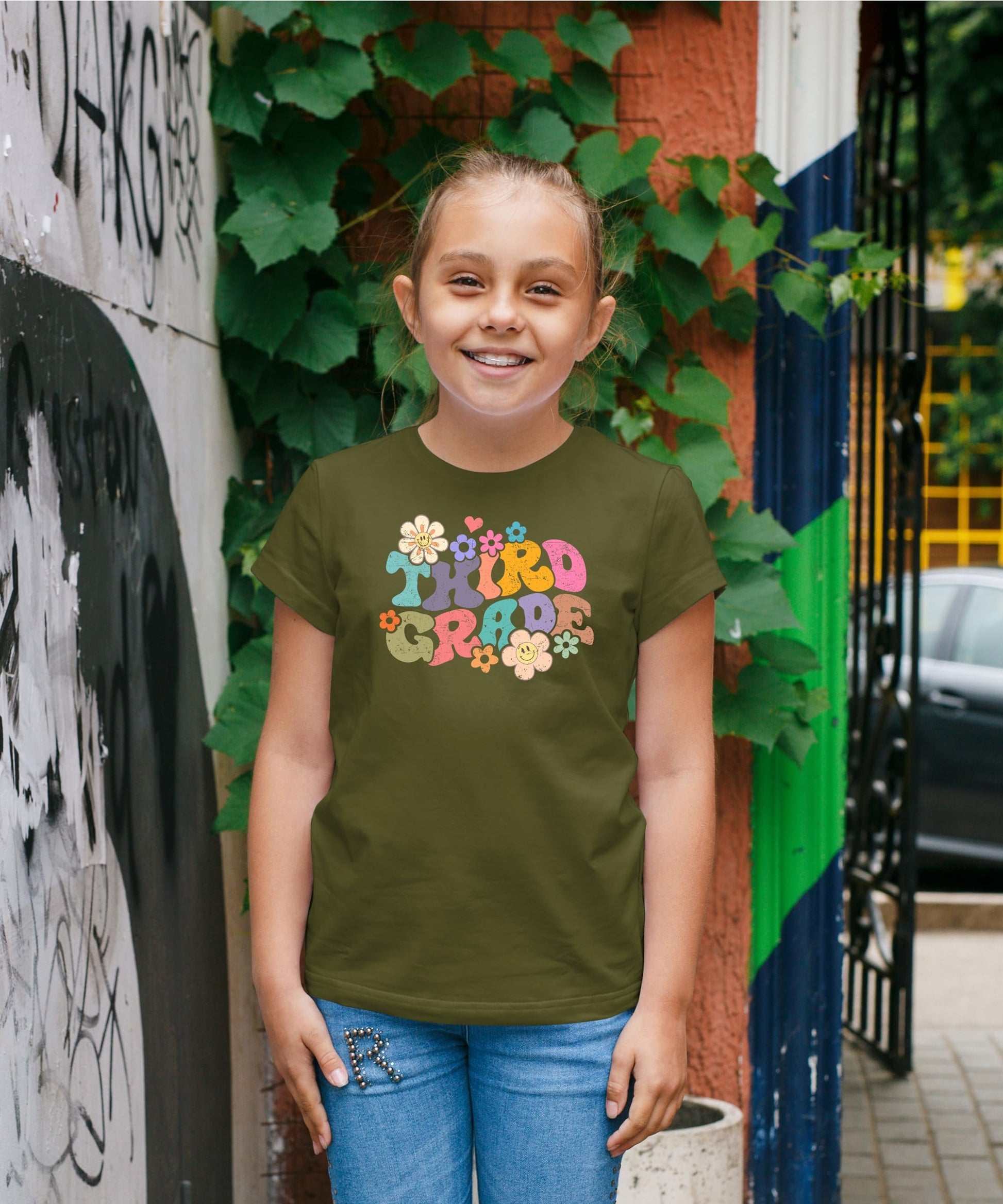 Flat lay of kids groovy daisy back to school shirt showing full graphic design