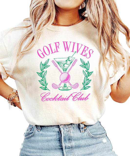 Ivory women's t-shirt with a funny Golf Wives Cocktail Club graphic featuring a dirty martini and crossed golf clubs