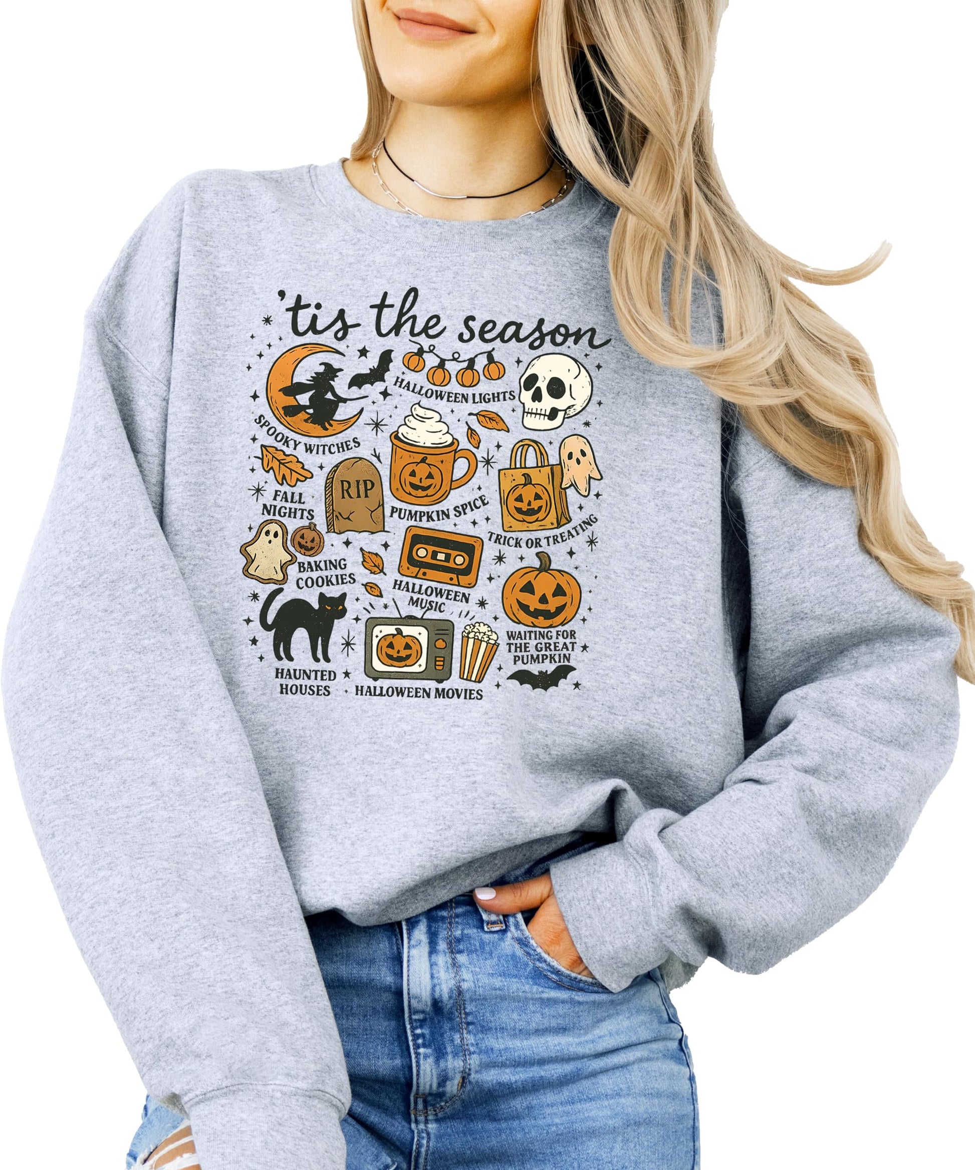Flat lay of gray Halloween sweatshirt with pumpkin ghost design styled with fall accessories