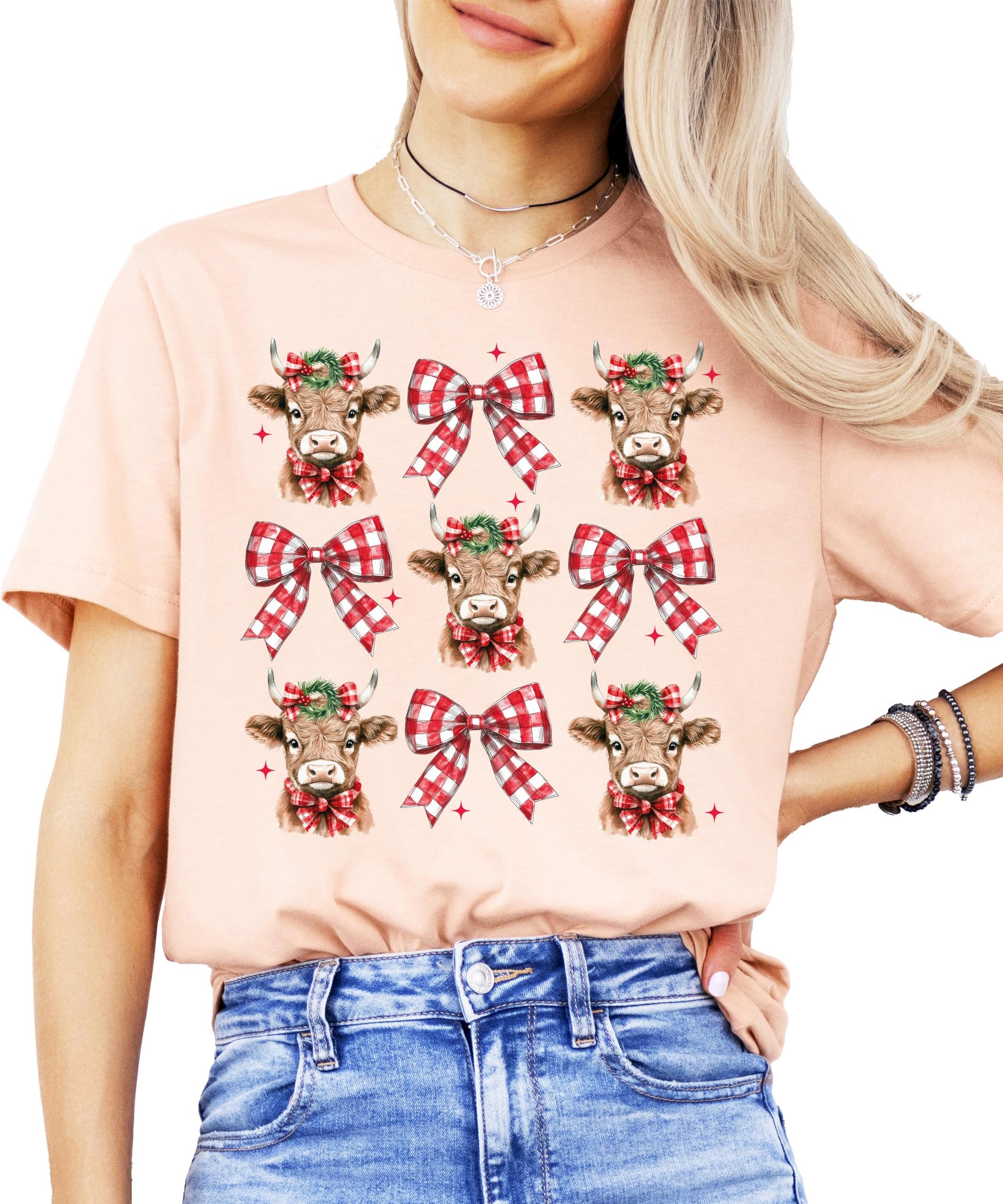 Front view of festive cow holiday graphic t-shirt for women and girls in peach
