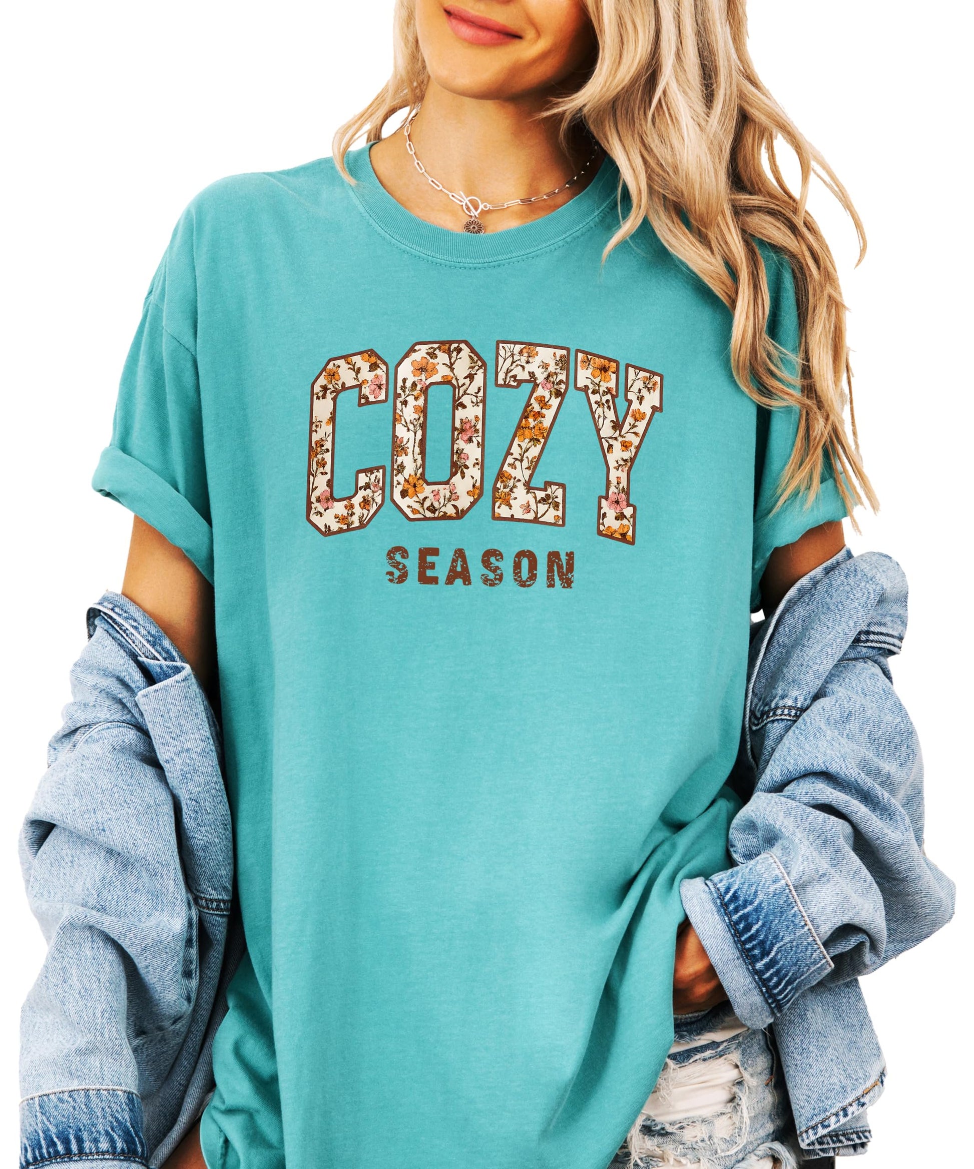 Styled flat lay of Cozy Season ivory fall t-shirt with orange floral graphic
