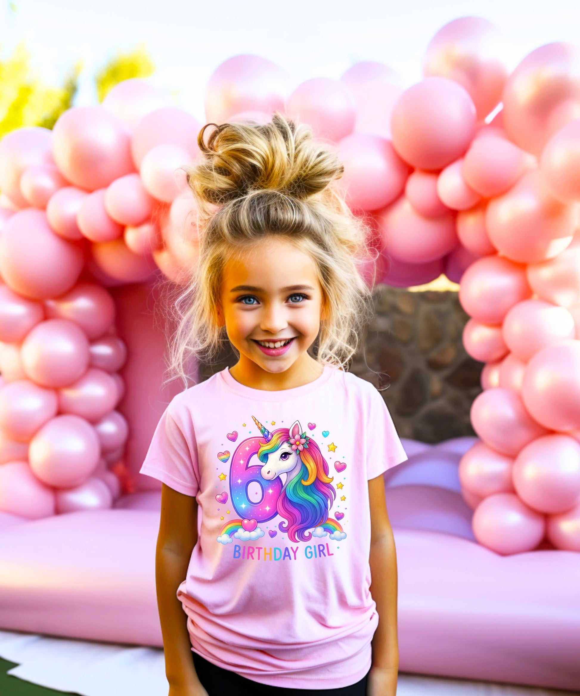 Flat lay of kids unicorn birthday graphic tee with bright rainbow colors and sparkly details