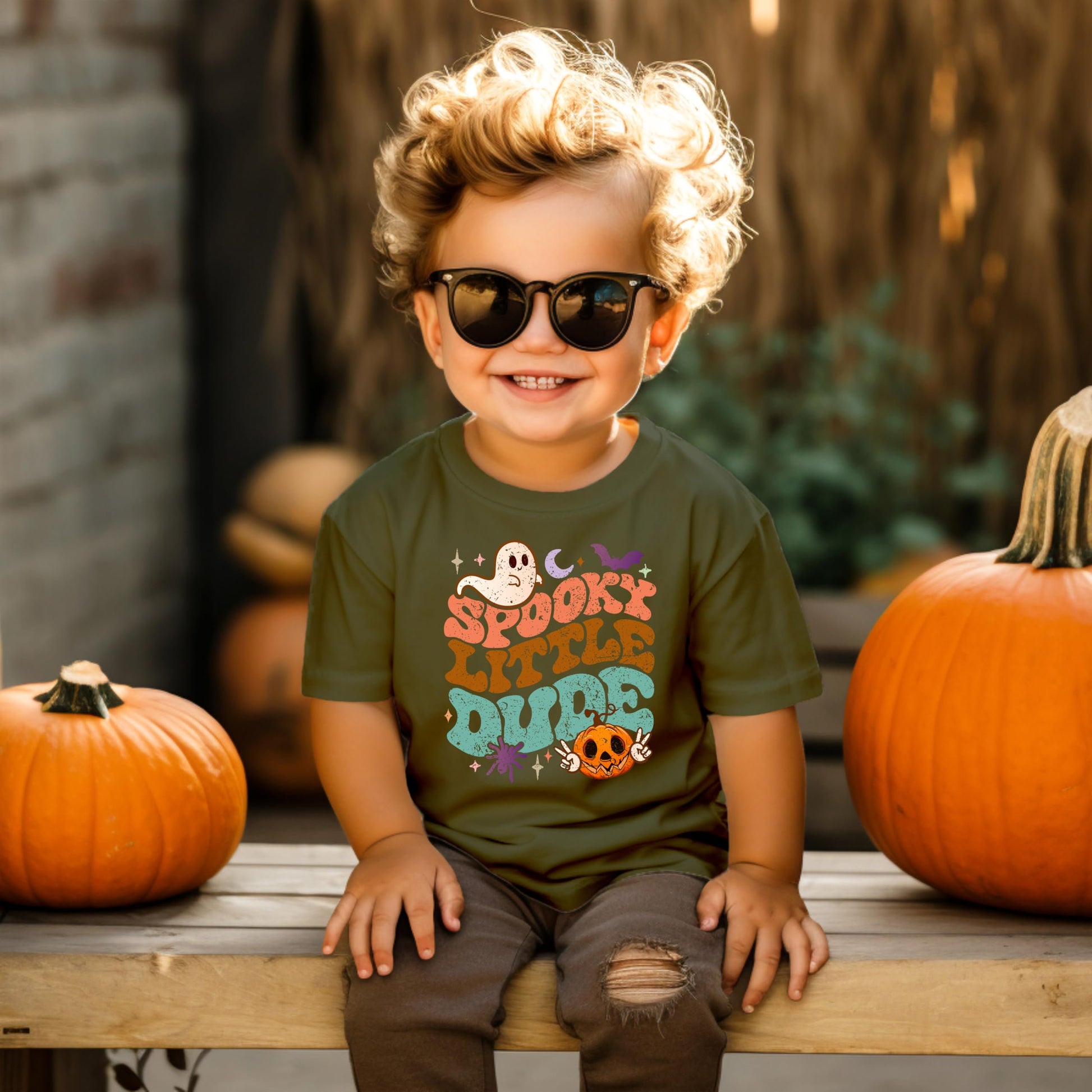 Toddler boy wearing Spooky Little Dude Halloween graphic shirt in natural color