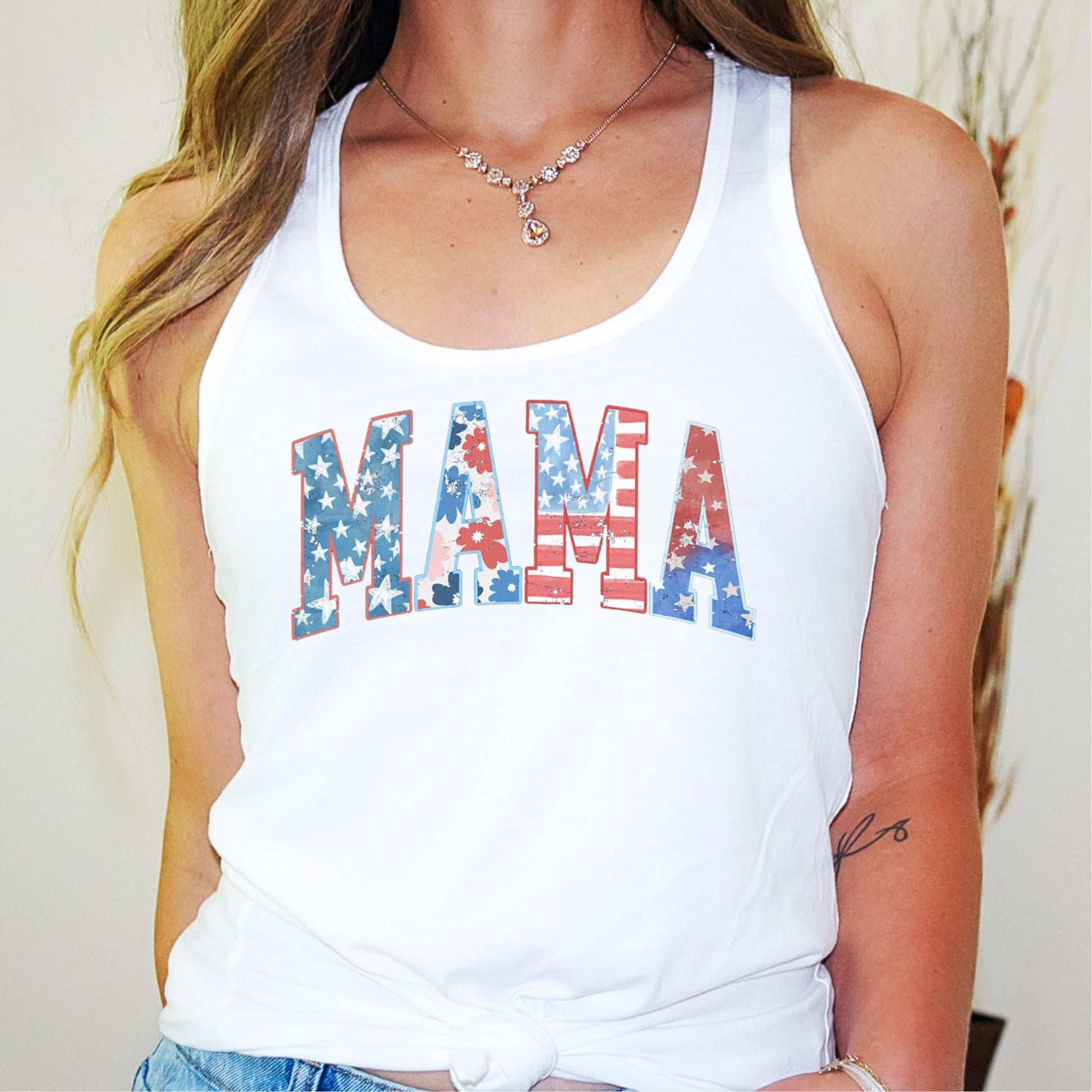 Detail view of patriotic floral MAMA print on women's white tank top for 4th of July