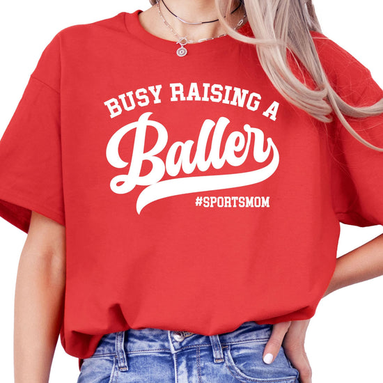 Close-up of Busy Raising a Baller print detail on black women's t-shirt
