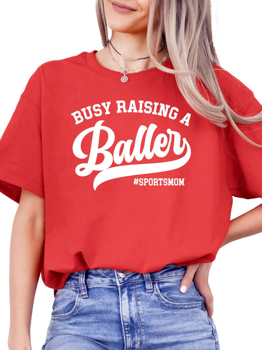 Close-up of Busy Raising a Baller print detail on black women's t-shirt