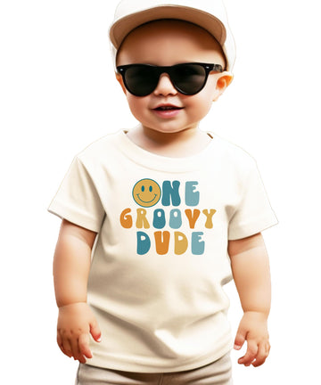 Flat lay of black groovy 1st birthday shirt for infant boys with colorful graphic