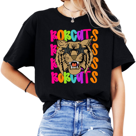 Adult woman wearing colorful Bobcats school spirit tee in natural color