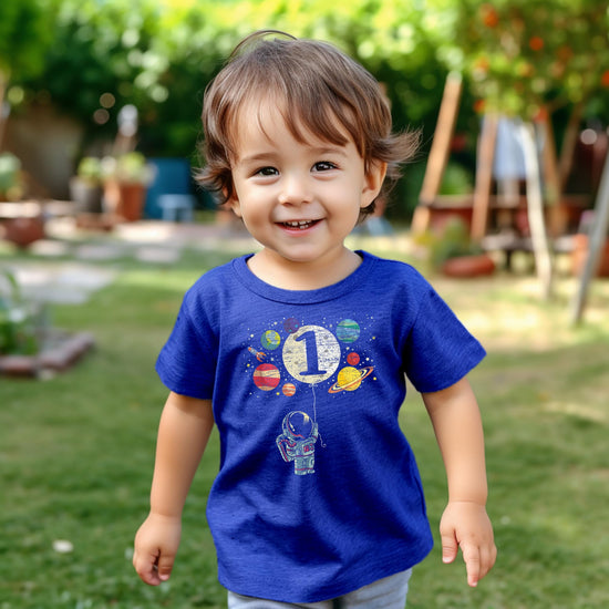 Side view of toddler 1st birthday space themed graphic tee with rocket and planet details