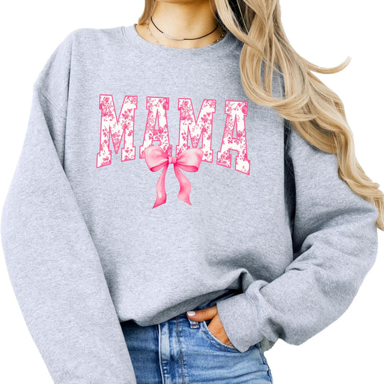 Close-up of pink bow MAMA graphic on black sweatshirt for women