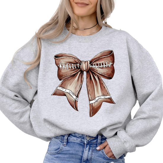 Front view of Football Coquette Bow Sweatshirt with ribbon detail on white fabric