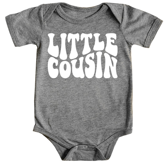 White Little Cousin retro bodysuit on mauve background with groovy lettering