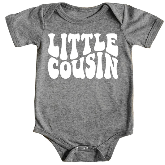 White Little Cousin retro bodysuit on mauve background with groovy lettering