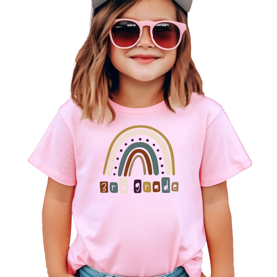 Front view of youth 3rd grade rainbow back to school shirt in pink