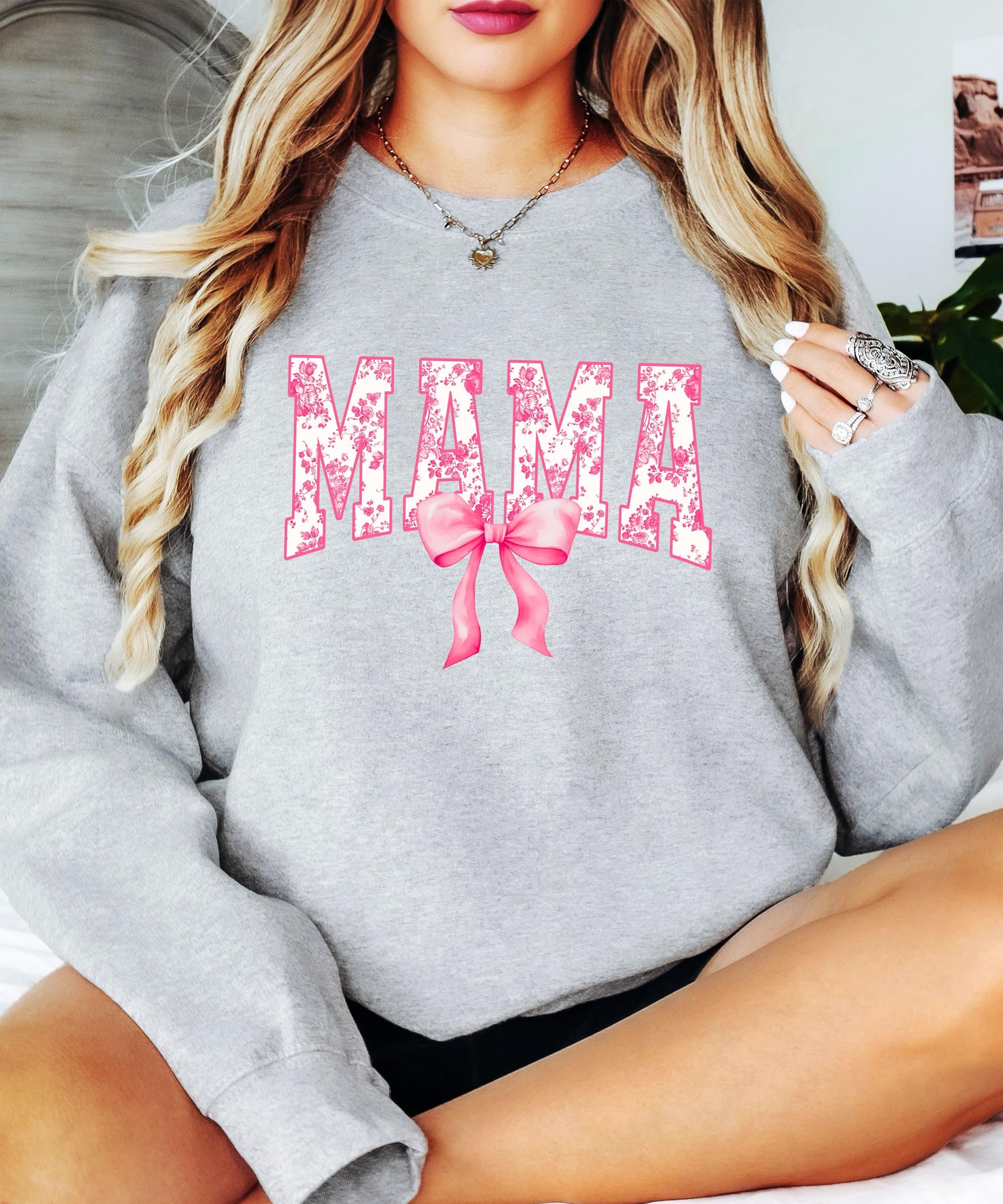 Back view of black Mama graphic sweatshirt on woman