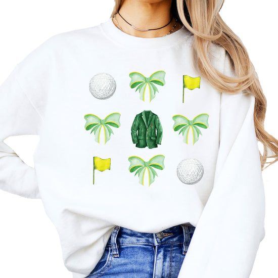 Women's white golf sweatshirt with playful tournament-style bow and golf ball design