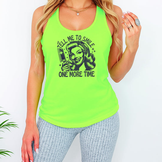 Flat lay styling of Tell Me to Smile funny graphic tank top for women