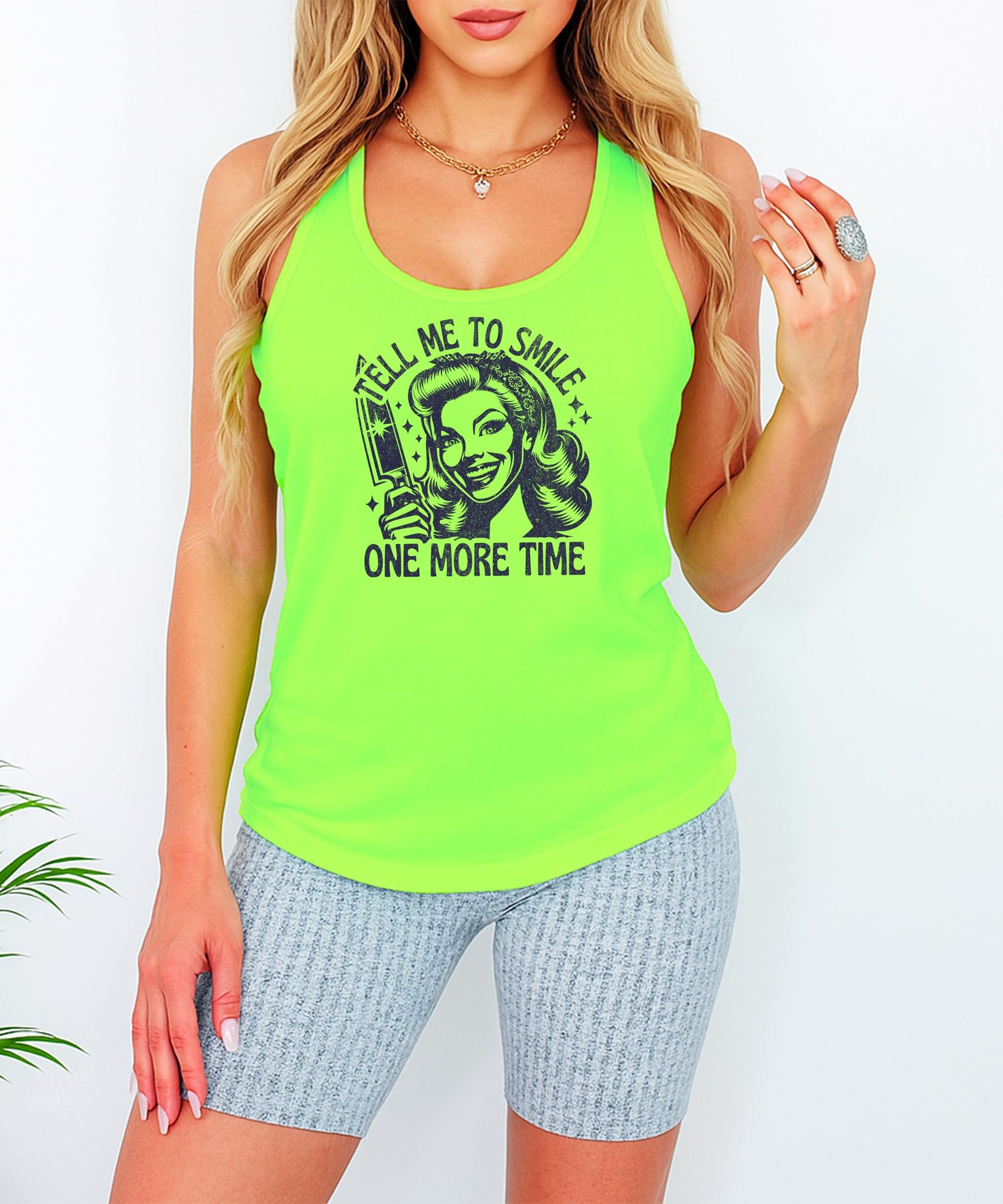 Flat lay styling of Tell Me to Smile funny graphic tank top for women