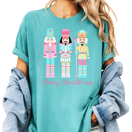 Close-up of pastel nutcracker holiday graphic print on women's seafoam tee
