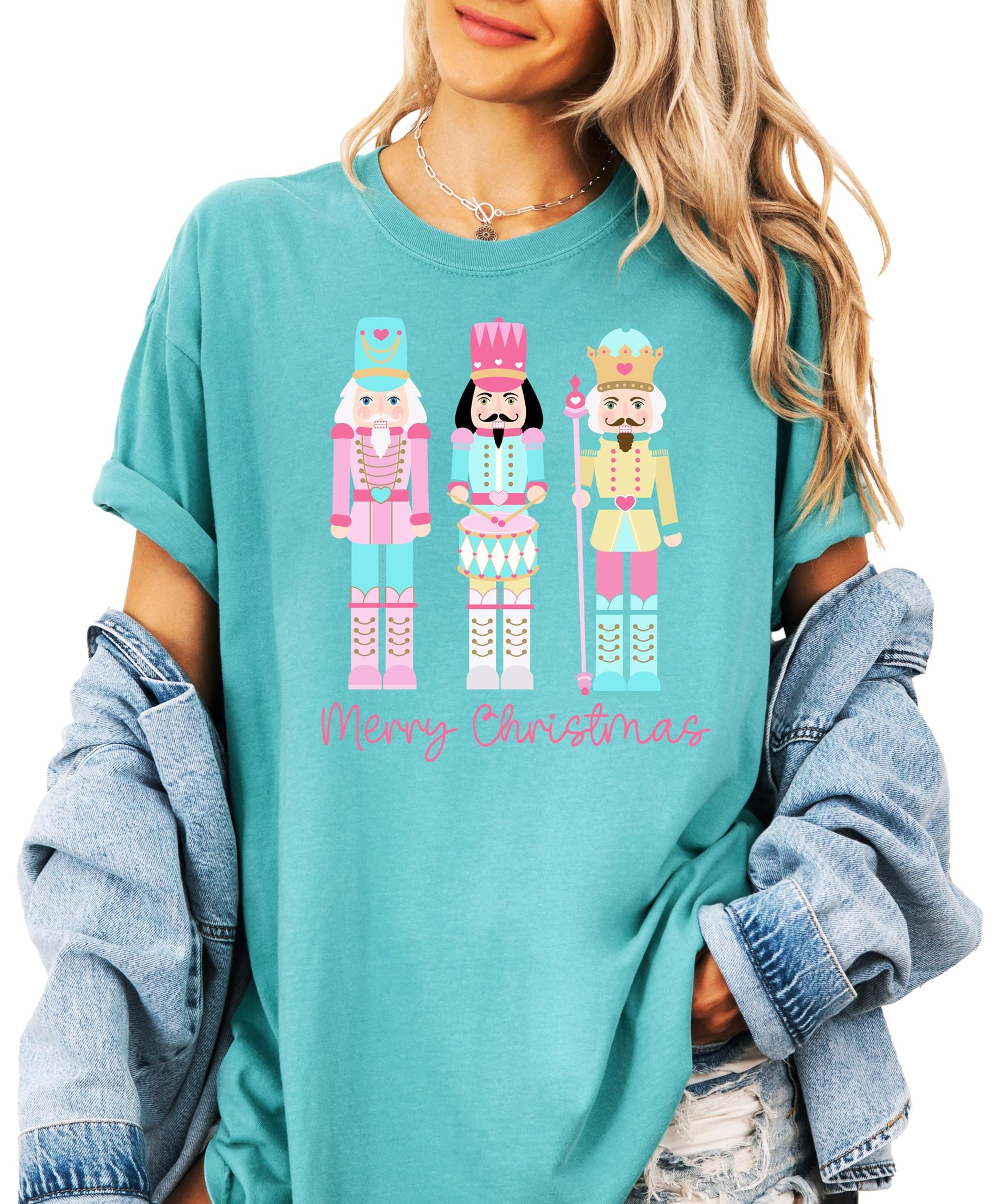 Close-up of pastel nutcracker holiday graphic print on women's seafoam tee