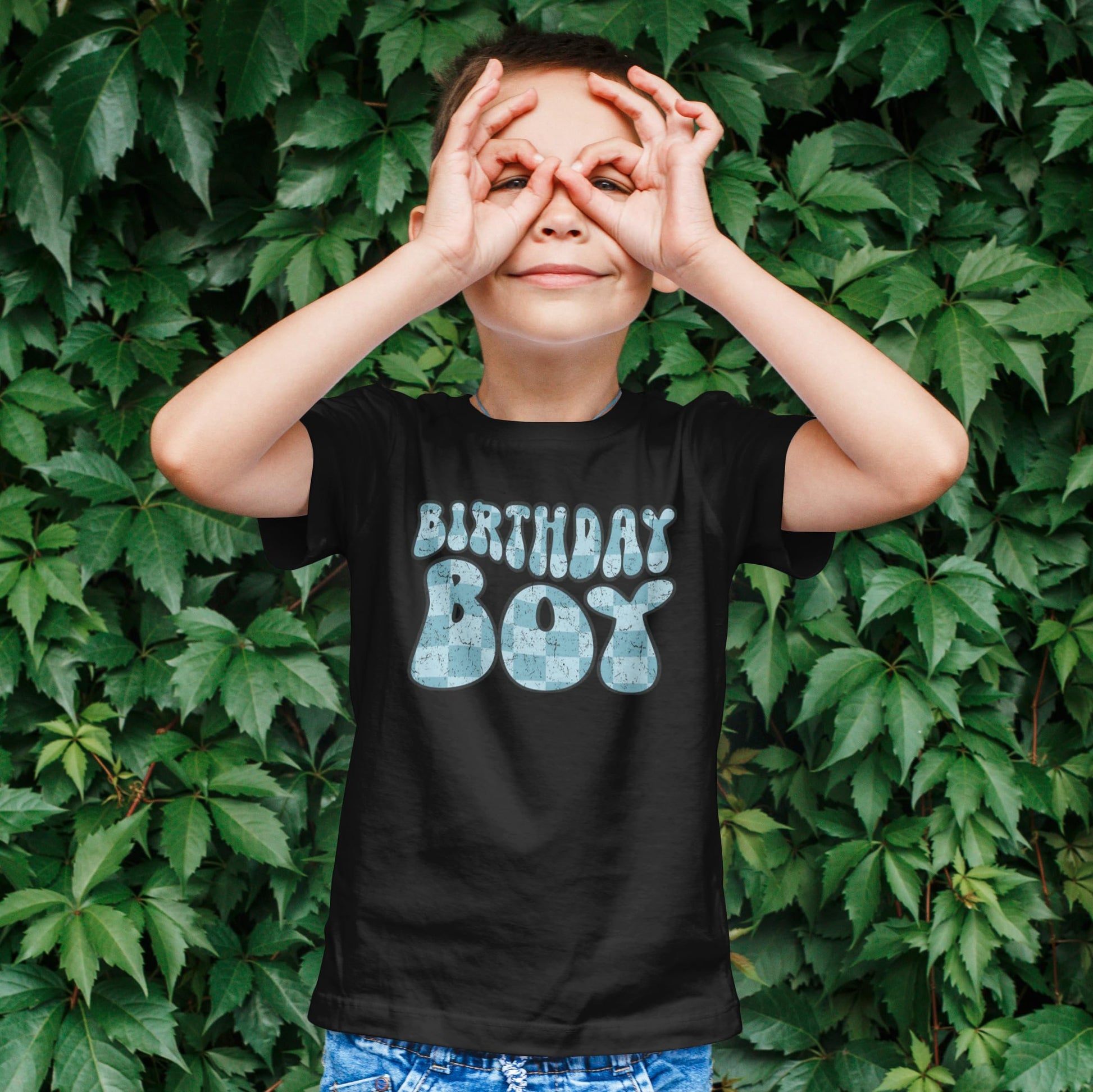 Close-up of groovy birthday graphic print on black boys birthday tee