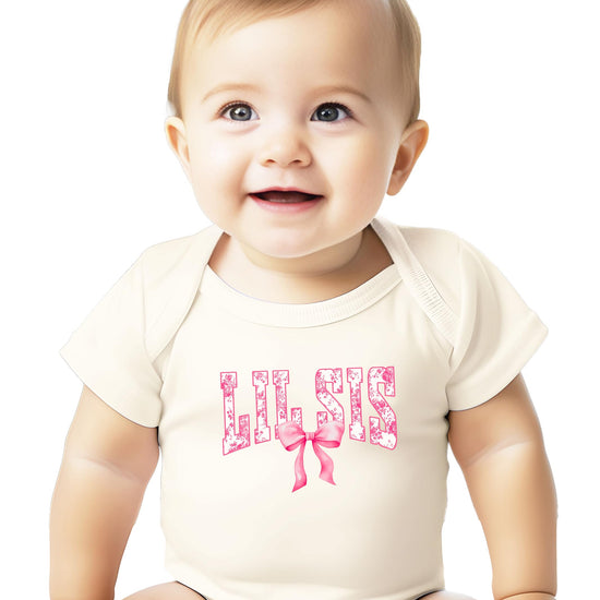 Little sister baby bodysuit laid flat showing full 'Lil Sis' floral print design