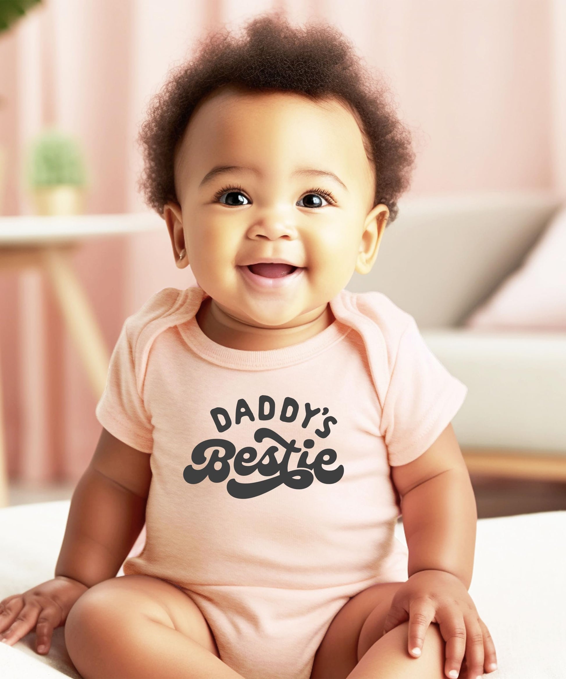 Side or back view of Daddy's Bestie peach baby bodysuit showing soft fabric and fit details