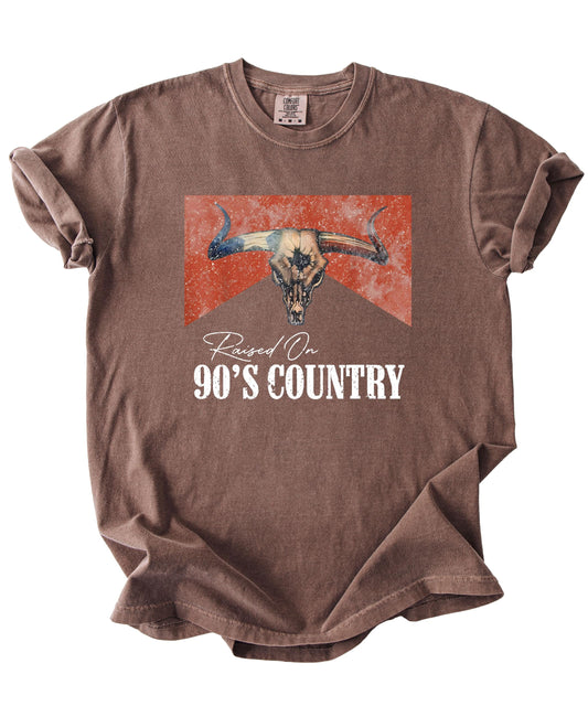 Close-up view of longhorn skull graphic print with 90s country music text design
